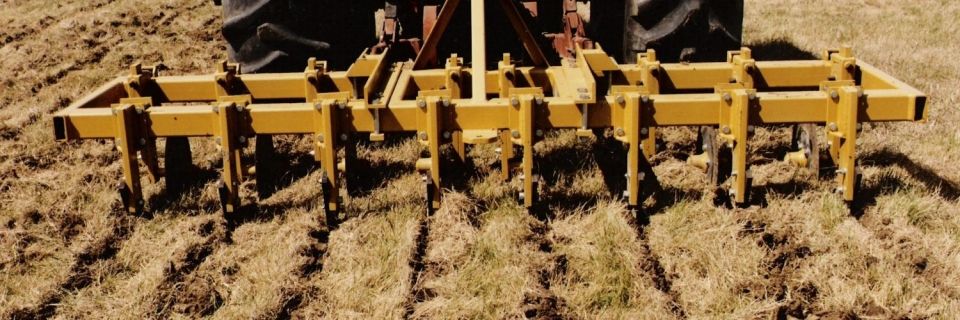 Hay King pasture renovator working a field behind a tractor